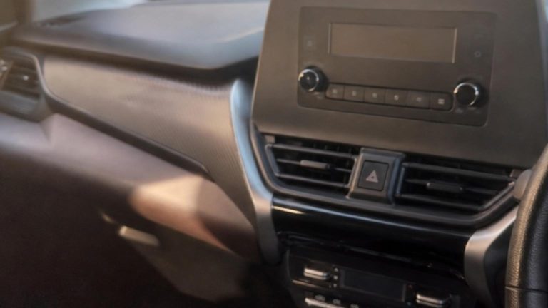 A close-up shot of the simplified dashboard of the Suzuki Fronx, sh…