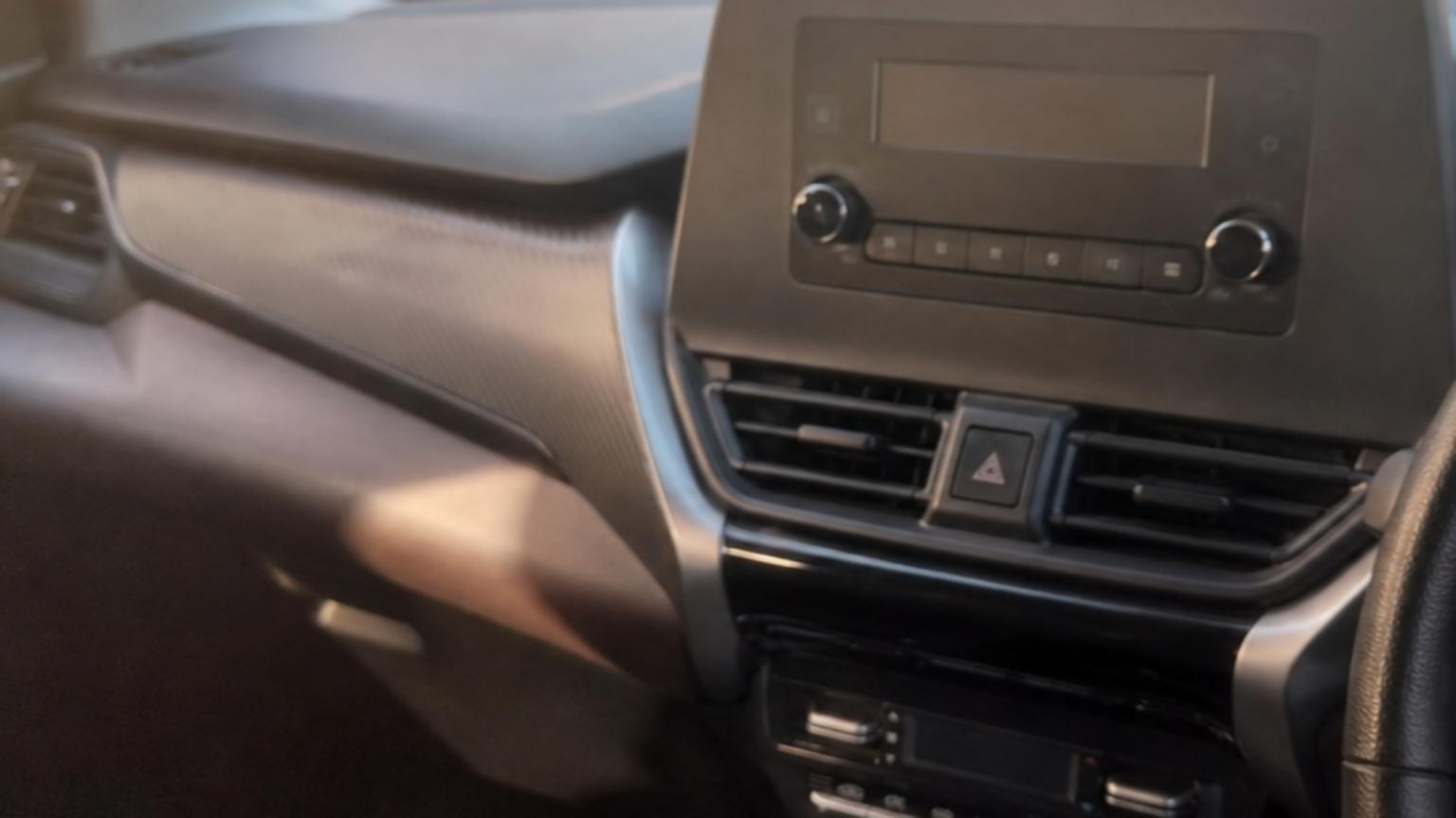 A close-up shot of the simplified dashboard of the Suzuki Fronx, sh…